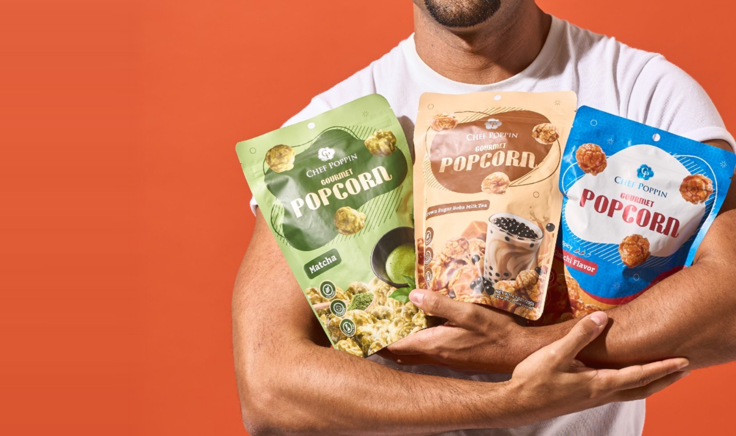 Man holding an armful of Chef Poppin bags