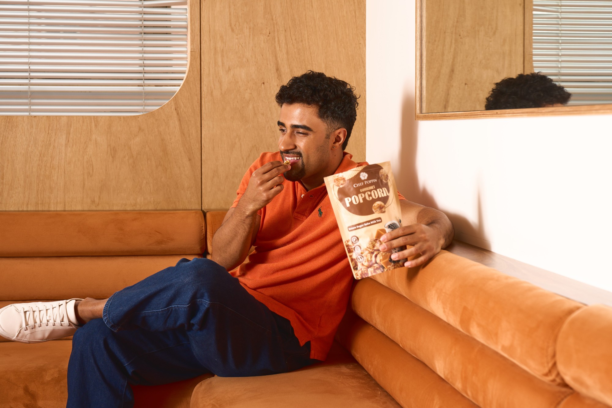 Man enjoying popcorn on the sofa