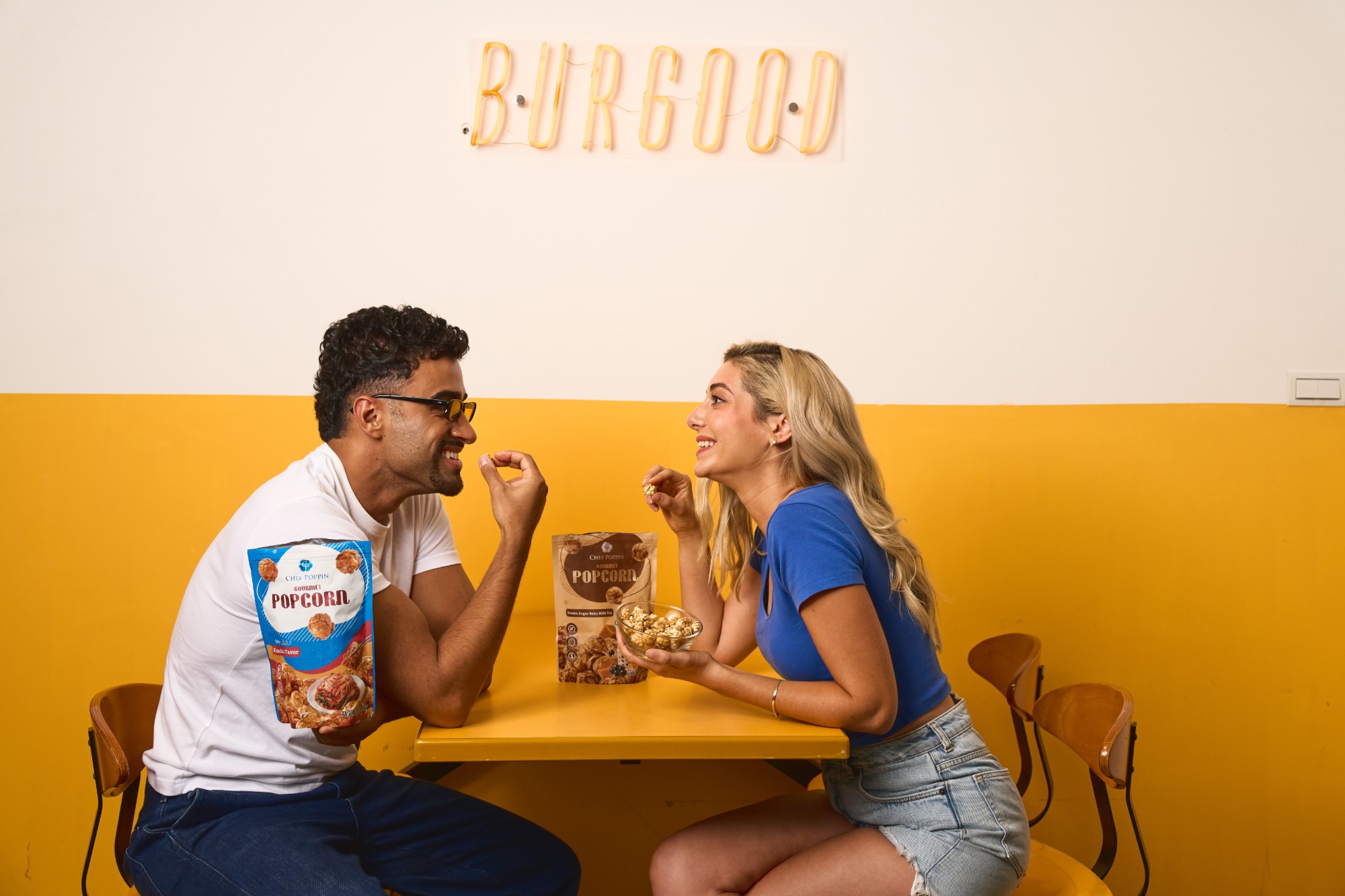 Two friends sharing a bag of popcorn
